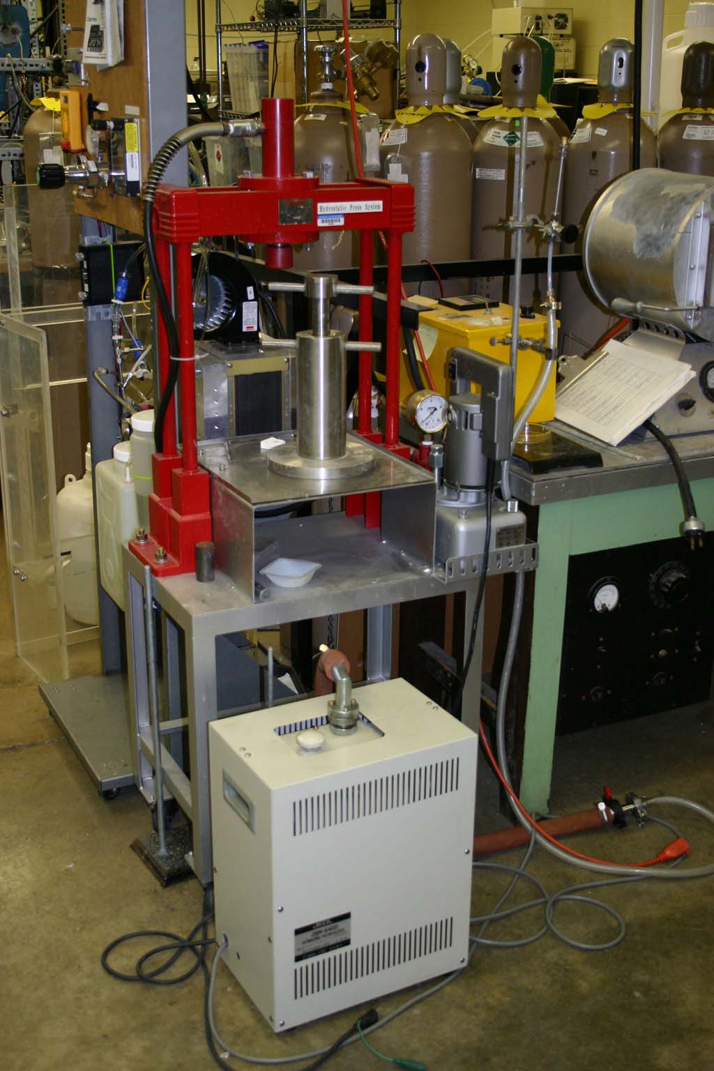 Isostatic press for compsction of source rods for crystal grower